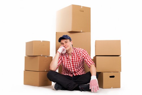 Professional movers handling boxes and furniture near Barbican